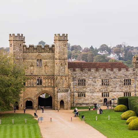 A view of Battle Abbey with people walking in the grounds.
