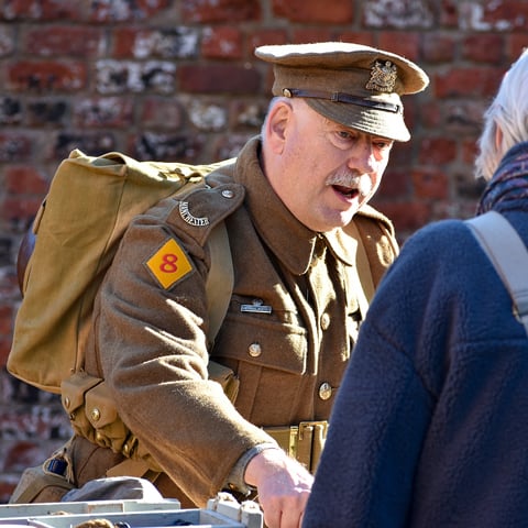 A reanactor dressed in a British First World War uniform.