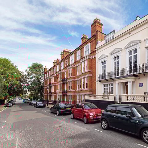 A street of grand terraced houses with large windows