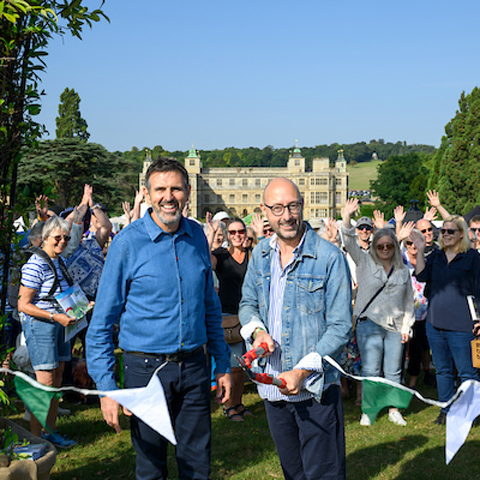 BBC Gardeners' World presenter, Adam Frost smiles next to a string of bunting being cut at BBC Gardener's World at Audley End. 