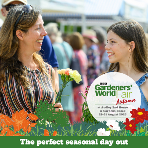 A woman and a child smile at each other, the woman is holding yellow flowers. A circle of text reads ‘BBC Gardeners’ World Fair Autumn at Audley End House and Gardens, Essex 29-31 August 2025’. Along the bottom of the image is illustrated flowers of orange, white and red. A green banner along the bottom with white text reading ‘The Perfect Seasonal Day Out’.