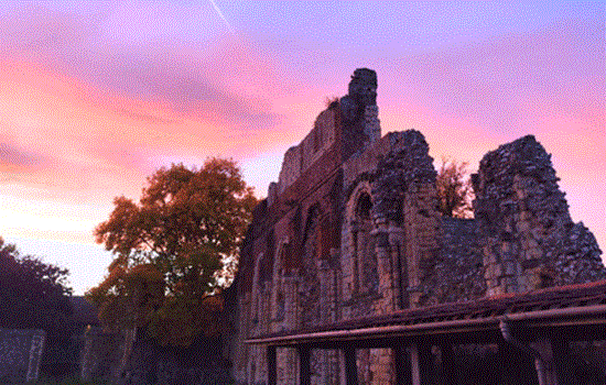 Ruins of St Augustine's Abbey under a colourful pink and blue sunset. Ruins of St Augustine's Abbey under a colourful pink and blue sunset.