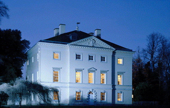The exterior of Marble Hill at night with several interior room lights on.  The exterior of Marble Hill at night with several interior room lights on.