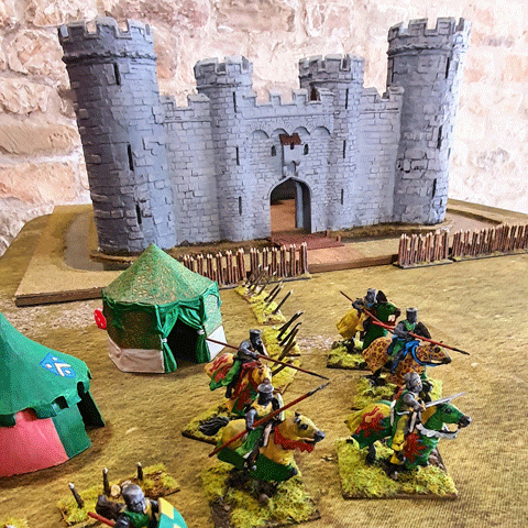 Miniature knights and horses stand in front of a toy castle, showcasing a detailed medieval scene.