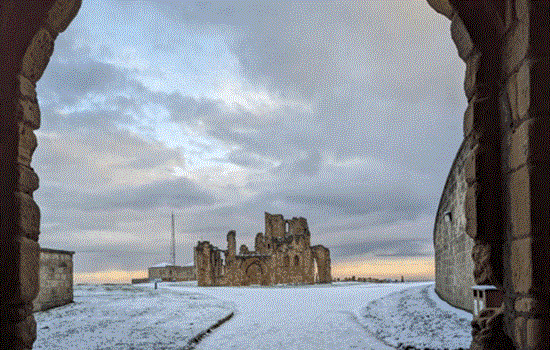 A view of Tynemouth Priory through an arch in the snow A view of Tynemouth Priory through an arch in the snow