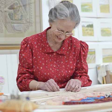 Image: Diana Springall embroidering 