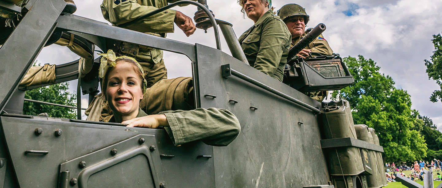 Photo of people dressed as Second World War soldiers and in period clothing in an armoured vehicle