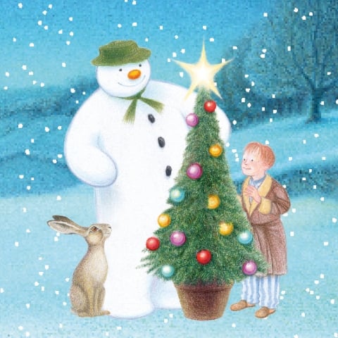An illustration from 'The Snowman' stood next to a Christmas tree, a hare and a young boy on a snowy night.