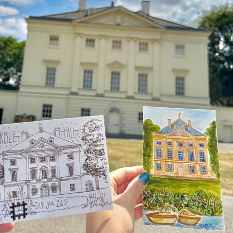 Two colourful postcards of Marble Hill being held up in front of Marble Hill House on a sunny day.