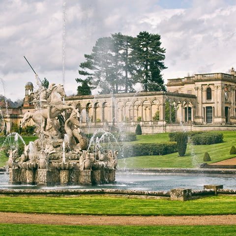The Perseus and Andromeda Fountain at Witley Court, with view of the ruins on a cloudy day in the background.