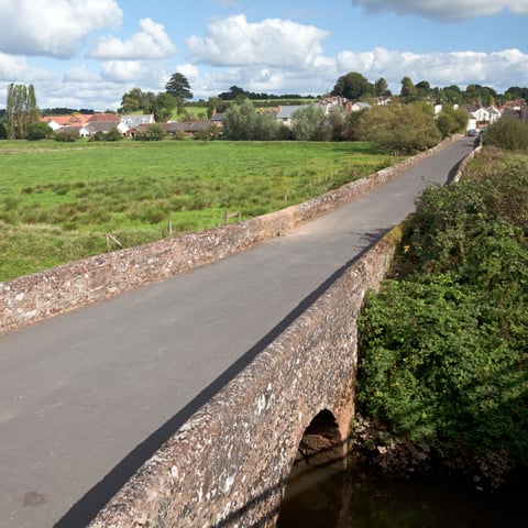 A view of a medieval bridge on a sunny day.