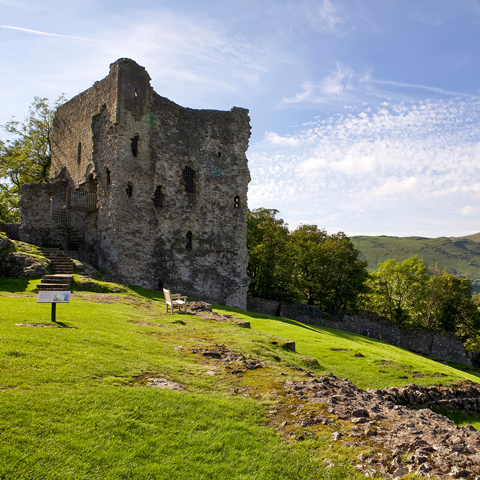 An exterior view of Peveril Castle on a sunny day.