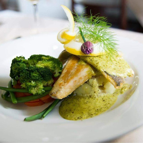 A close-up of a well presented meal on a white dish.