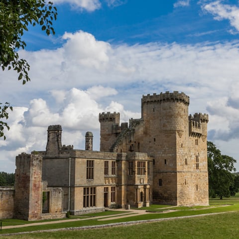 A view of the exterior of Belsay Castle on a sunny day.