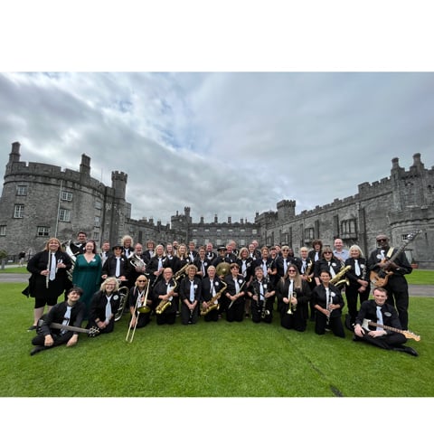 The Hot Aire! band musicians pose for a photo outside Kilkenny Castle.