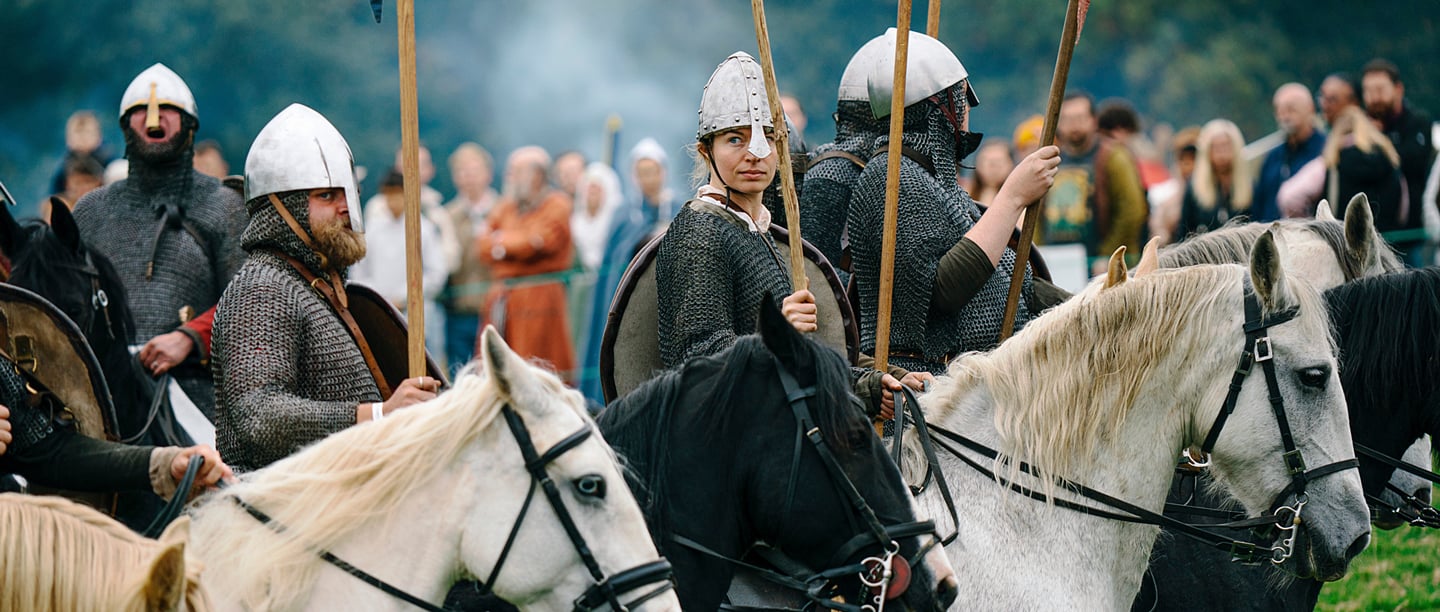 Re-enactors on horseback act out the Battle of Hastings wearing full medieval armour..